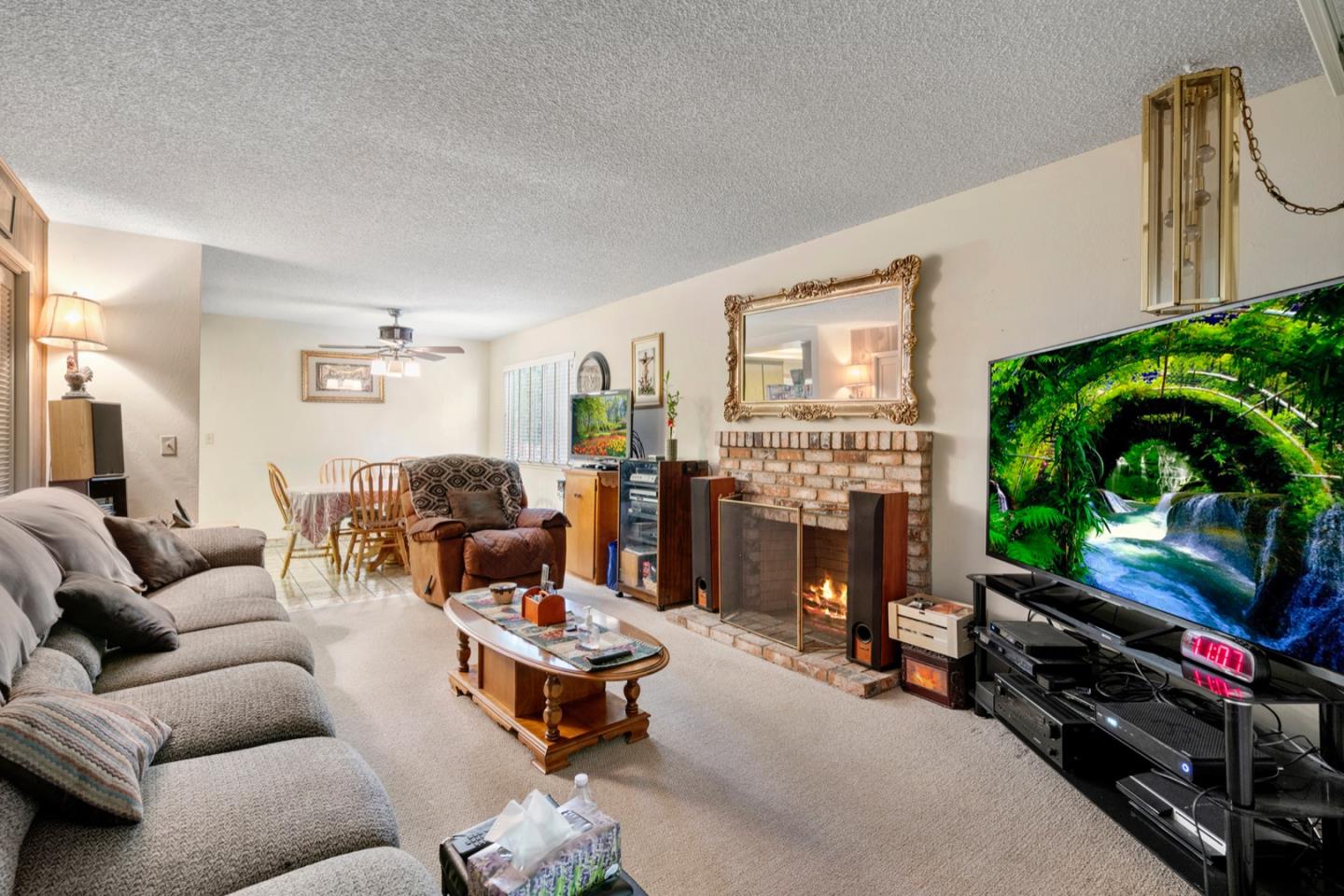 2885 Berryessa Road San Jose, CA 95132 - Photo 19 of 21 a living room with furniture fireplace and flat screen tv