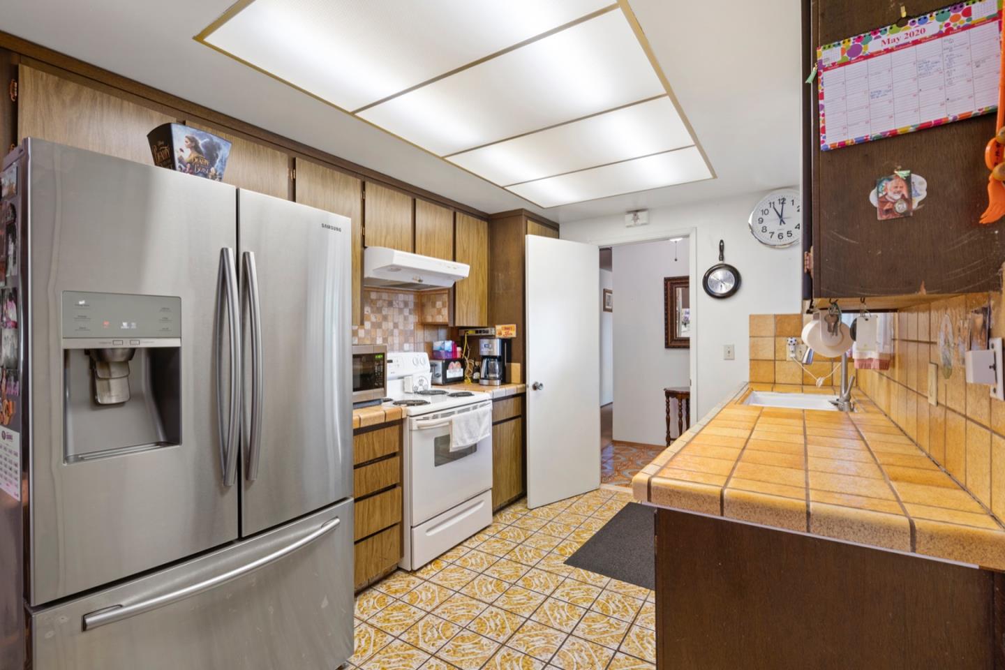 2885 Berryessa Road San Jose, CA 95132 - Photo 3 of 21 a kitchen with stainless steel appliances granite countertop a refrigerator a oven and white cabinets