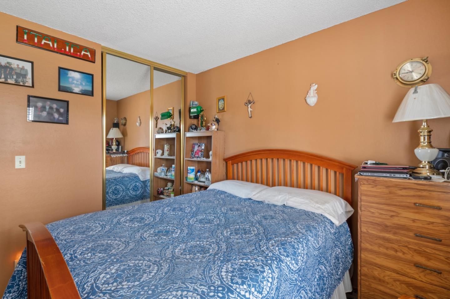 2885 Berryessa Road San Jose, CA 95132 - Photo 9 of 21 a bedroom with a large bed and a chandelier
