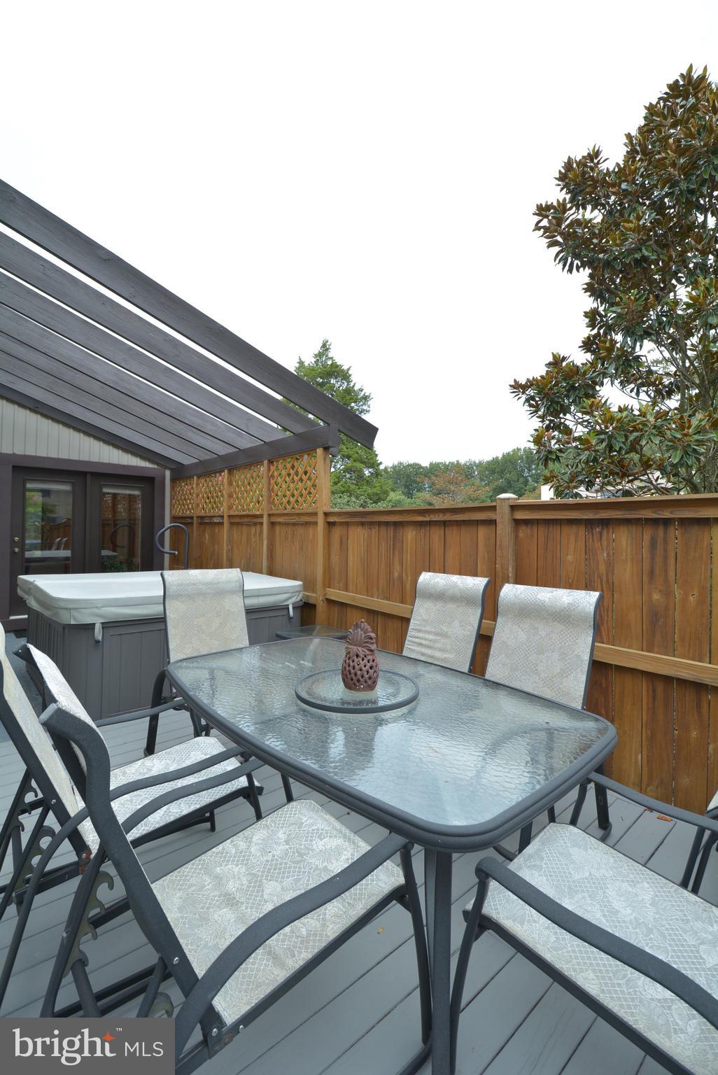 5947 Hall Street Springfield, VA 22152 - Photo 11 of 38 L shaped deck has outdoor seating and hot tub!