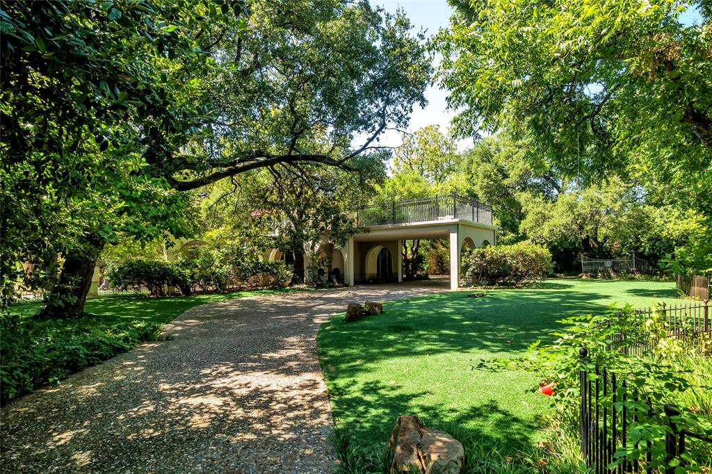 9909 Preston Road Dallas, TX 75230 - Photo 13 of 22 a front view of a house with a yard and trees