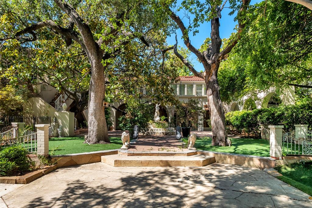 9909 Preston Road Dallas, TX 75230 - Photo 16 of 22 a view of brick house with a clock tower in middle of garden
