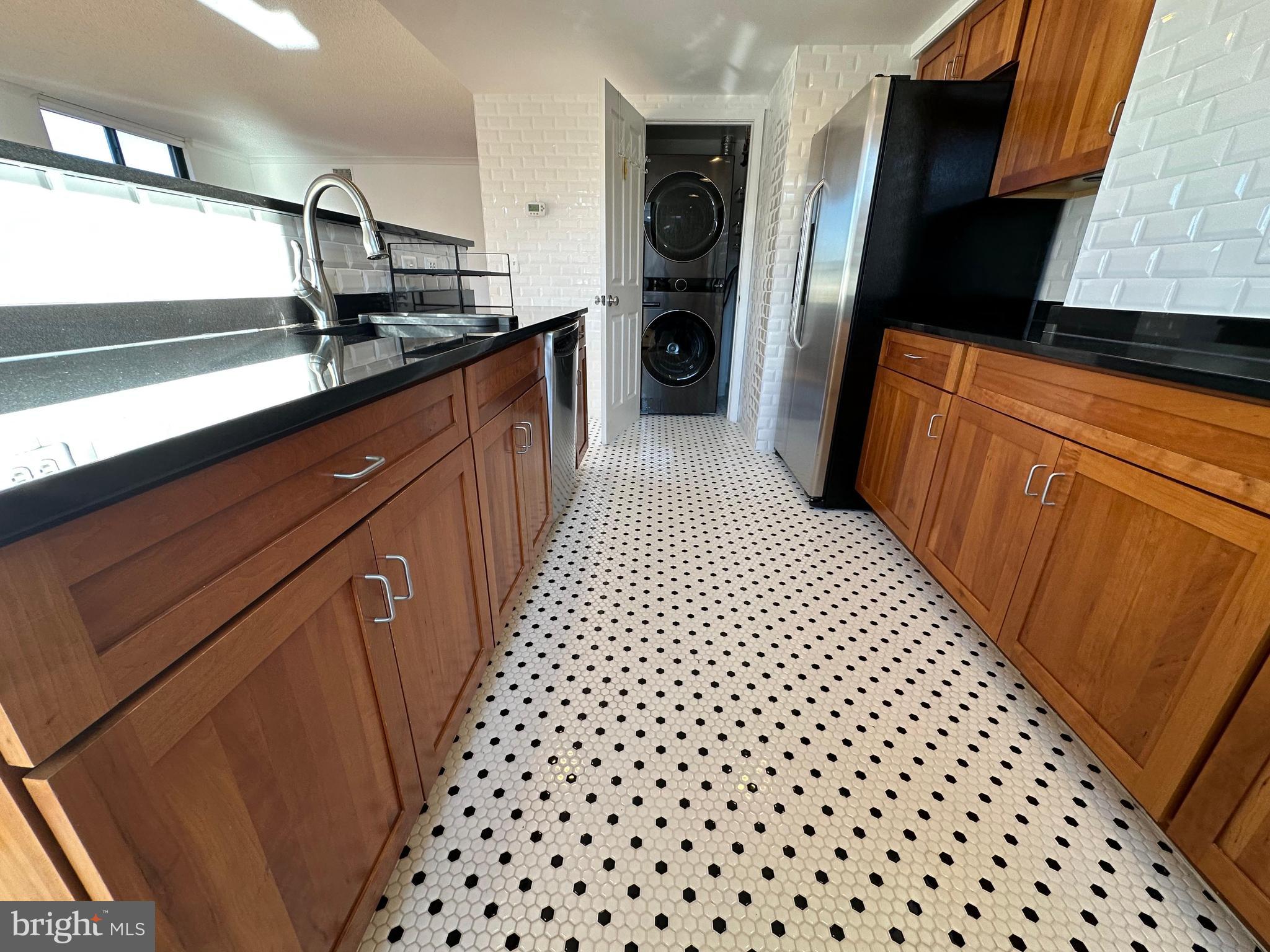 1220 North Fillmore Street, Unit 901 Arlington, VA 22201 - Photo 16 of 35 a kitchen with stainless steel appliances a refrigerator and a sink
