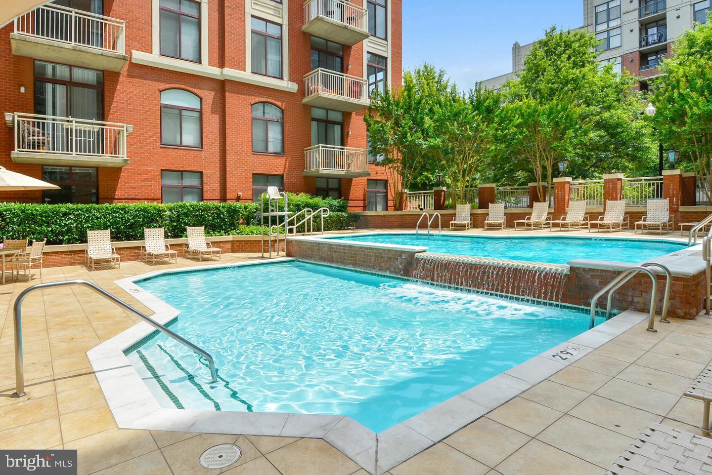 1220 North Fillmore Street, Unit 901 Arlington, VA 22201 - Photo 24 of 35 a view of a swimming pool with a lounge chairs