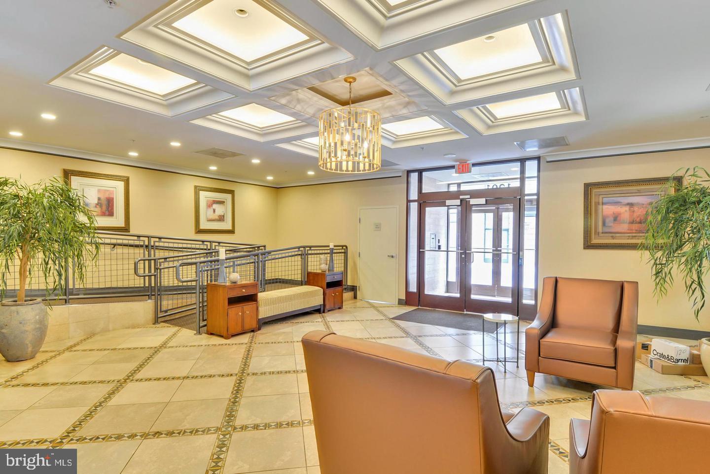 1220 North Fillmore Street, Unit 901 Arlington, VA 22201 - Photo 25 of 35 a lobby with furniture and floor to ceiling window