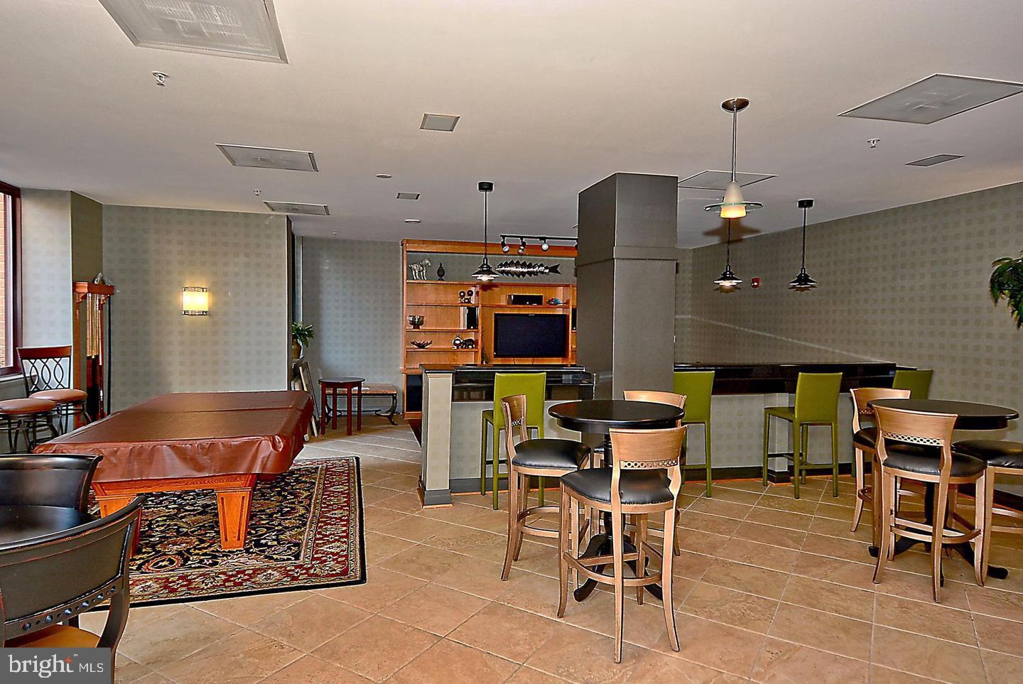 1220 North Fillmore Street, Unit 901 Arlington, VA 22201 - Photo 27 of 35 a outdoor kitchen with a large window and chairs