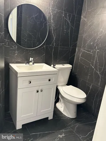a bathroom with a sink toilet and mirror