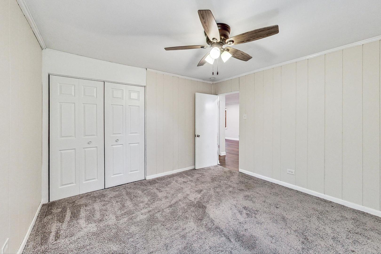 1205 183rd Street Homewood, IL 60430 - Photo 11 of 20 a view of a livingroom with a ceiling fan & a ceiling fan