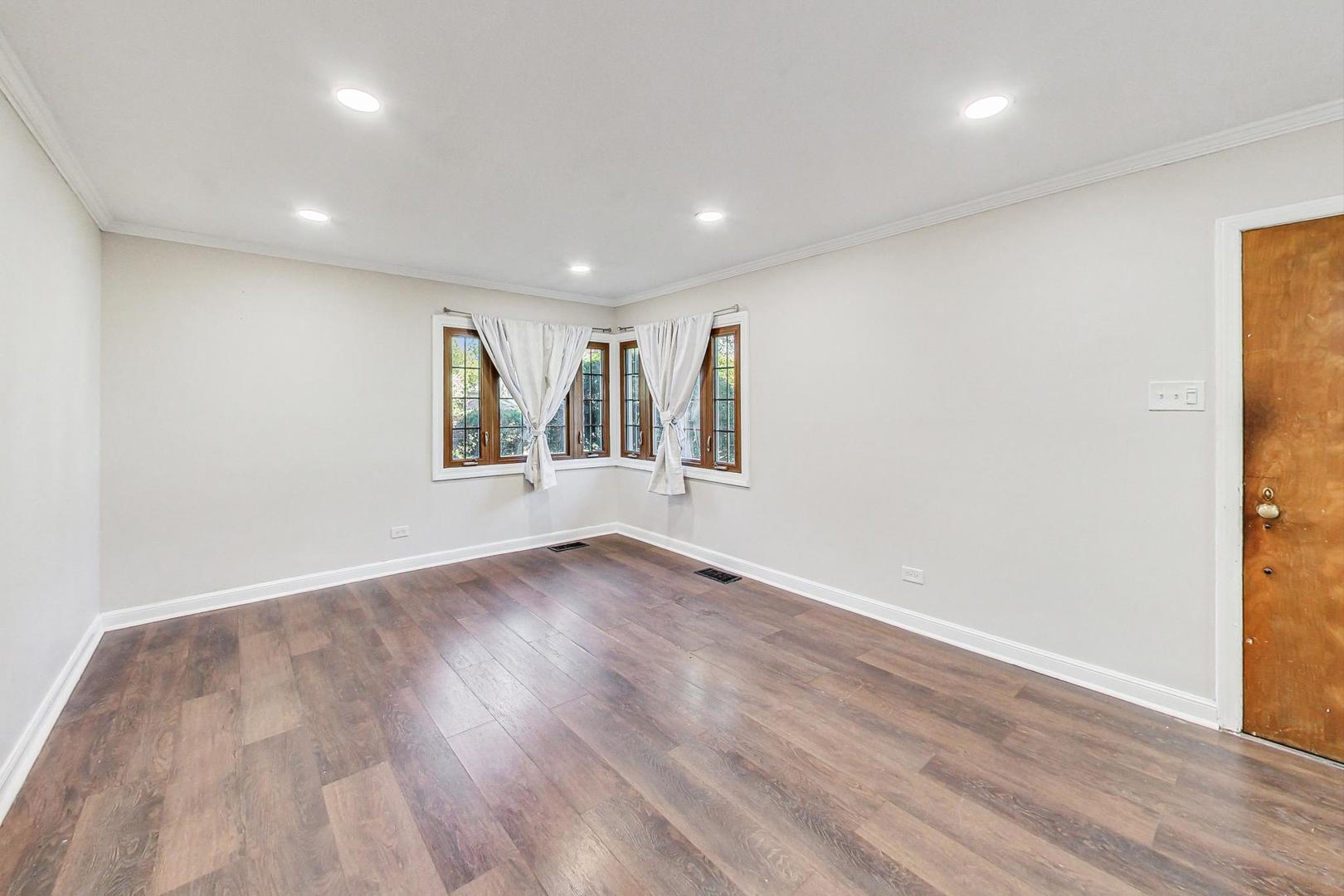 1205 183rd Street Homewood, IL 60430 - Photo 3 of 20 an empty room with wooden floor and windows