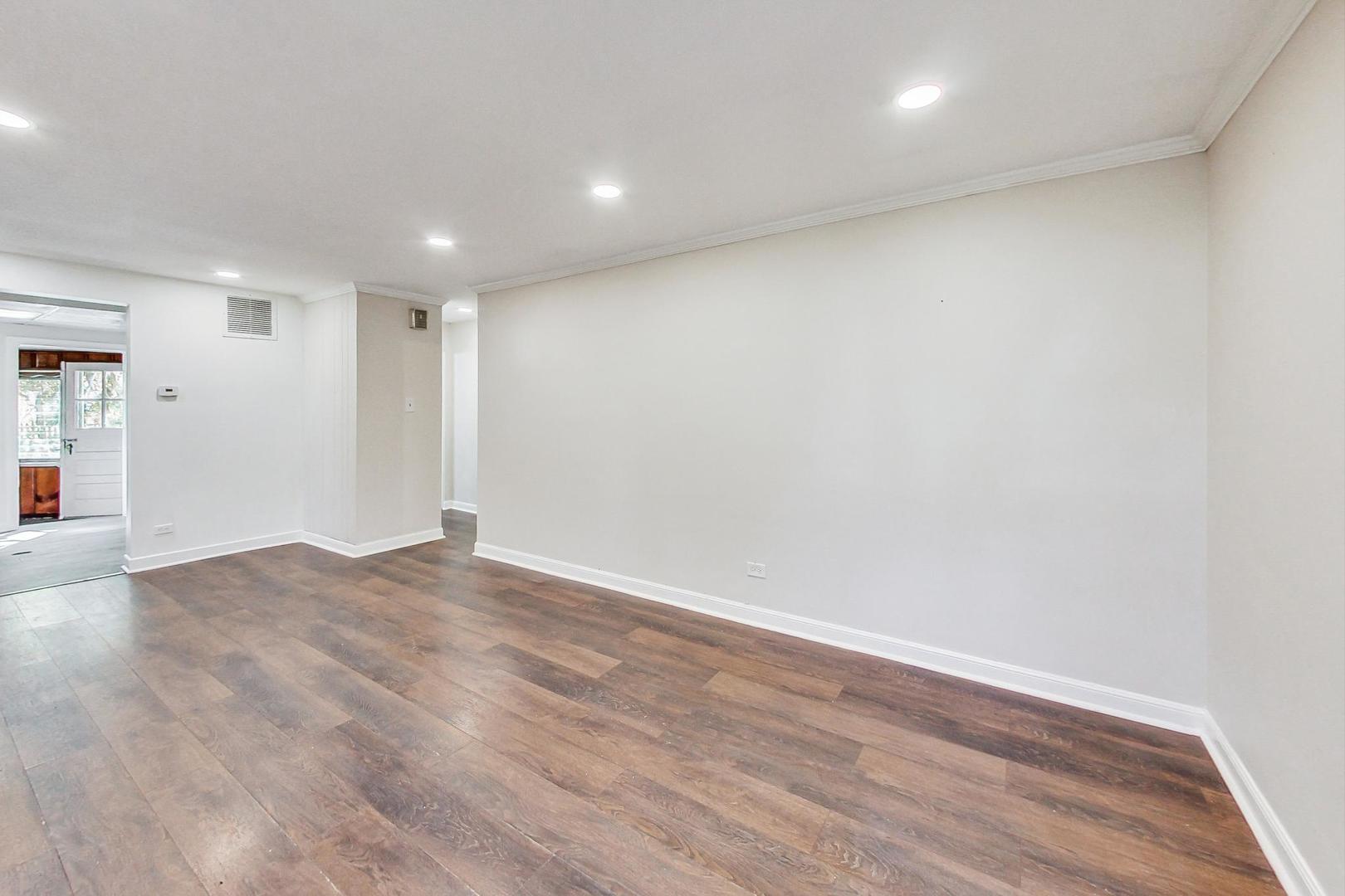 1205 183rd Street Homewood, IL 60430 - Photo 4 of 20 an empty room with wooden floor and windows