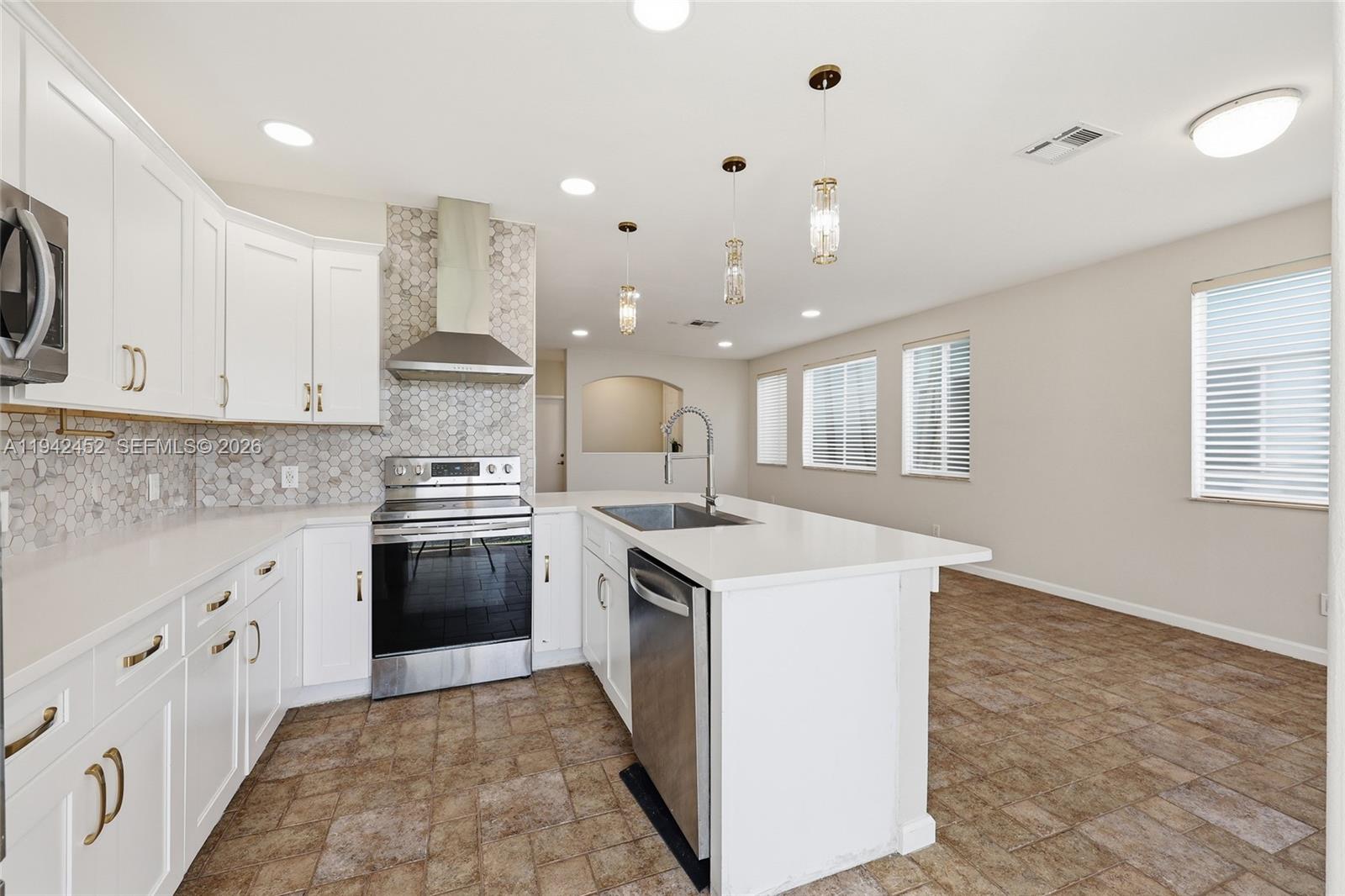 a kitchen with a stove sink and a refrigerator