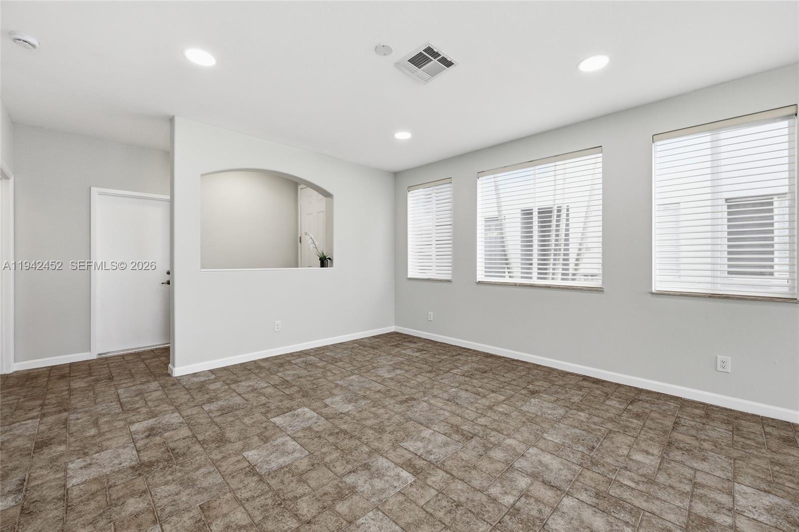 3059 Laurel Ridge Circle Riviera Beach, FL 33404 - Photo 12 of 25 wooden floor in an empty room with a window