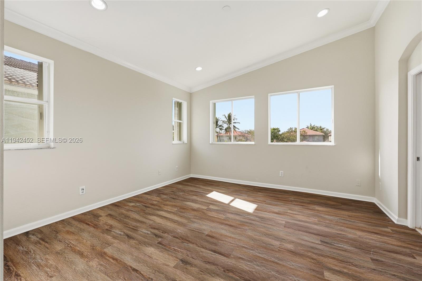3059 Laurel Ridge Circle Riviera Beach, FL 33404 - Photo 14 of 25 a view of empty room with wooden floor and fan
