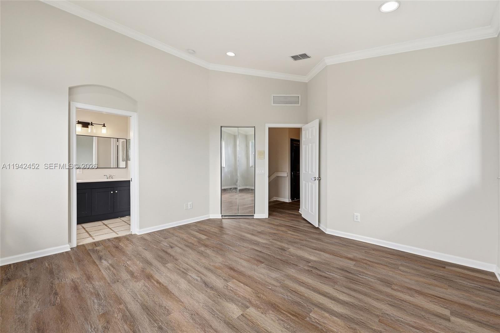 3059 Laurel Ridge Circle Riviera Beach, FL 33404 - Photo 17 of 25 a view of an empty room with wooden floor and closet