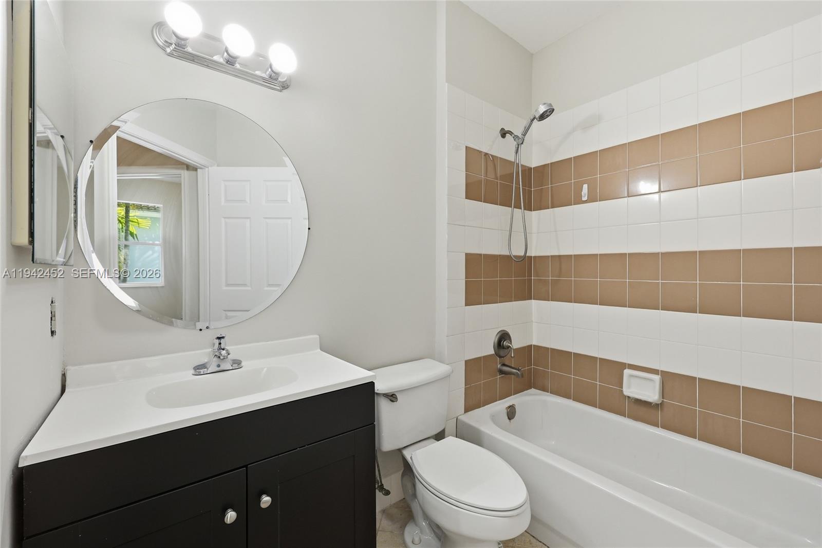 3059 Laurel Ridge Circle Riviera Beach, FL 33404 - Photo 21 of 25 a bathroom with a sink a toilet a mirror and shower