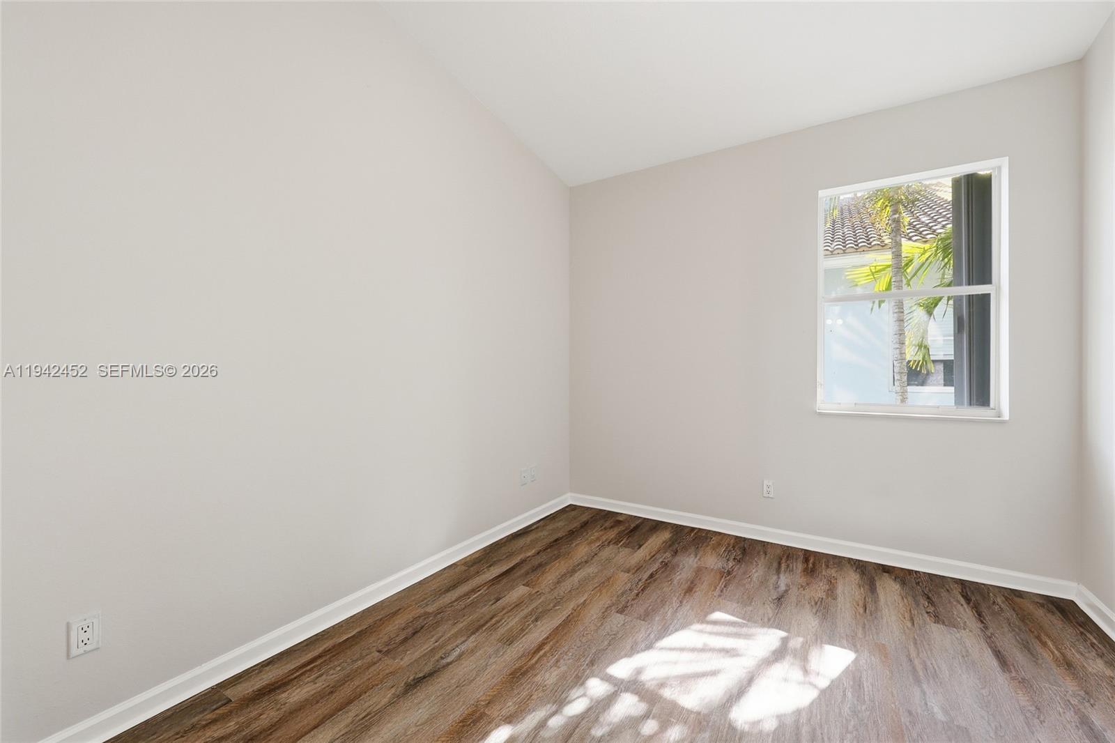 3059 Laurel Ridge Circle Riviera Beach, FL 33404 - Photo 22 of 25 a view of room with window and wooden floor