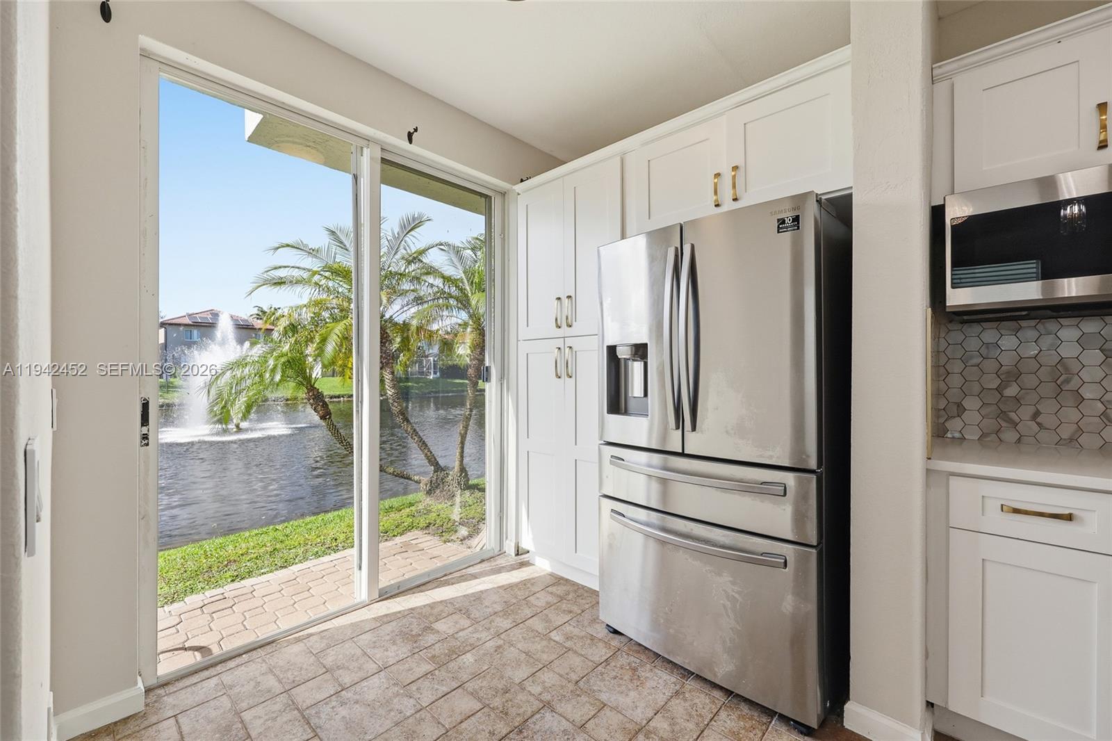 3059 Laurel Ridge Circle Riviera Beach, FL 33404 - Photo 5 of 25 a kitchen with stainless steel appliances a refrigerator and a sink