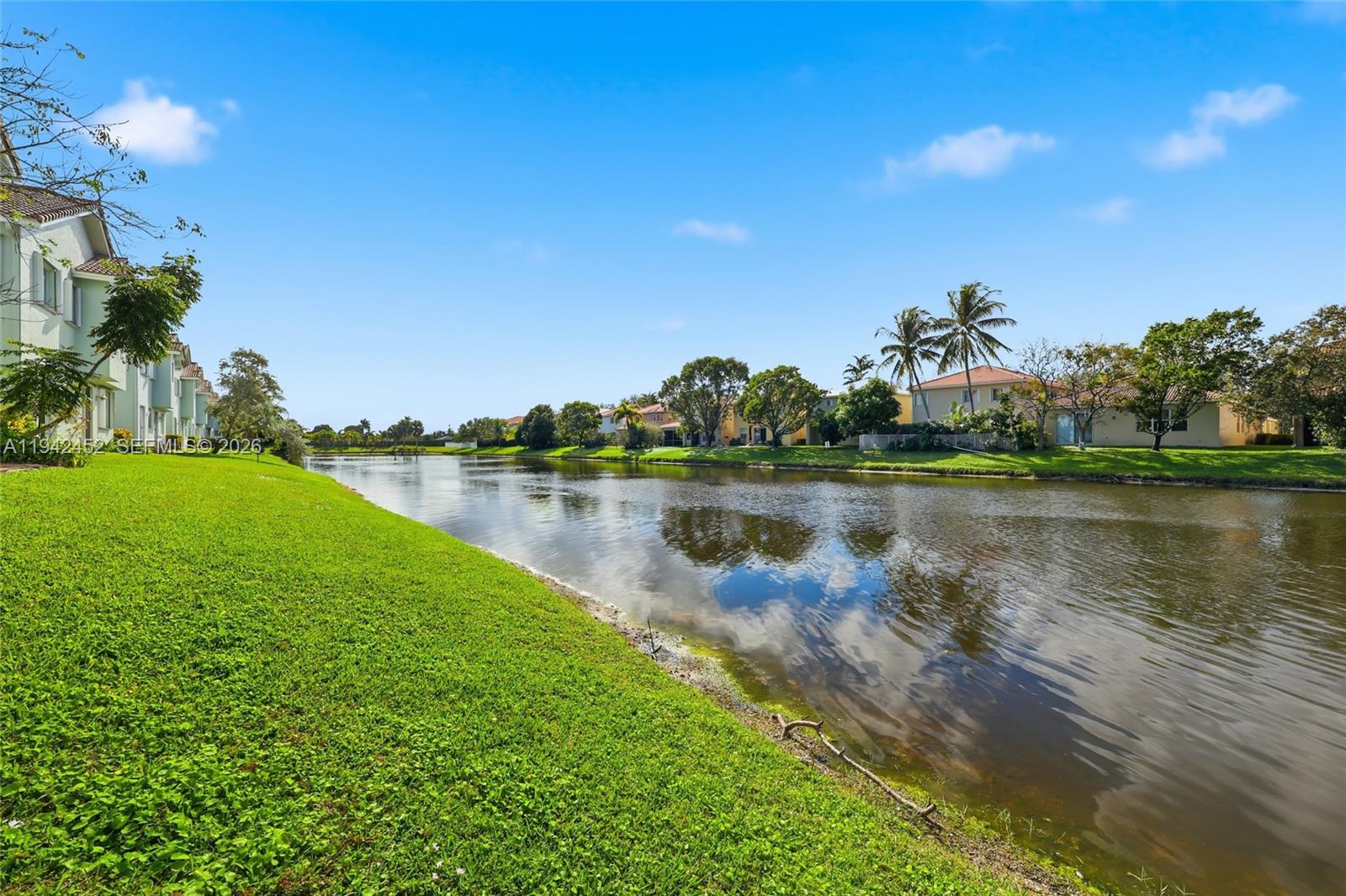 3059 Laurel Ridge Circle Riviera Beach, FL 33404 - Photo 6 of 25 a view of a lake with houses in the back