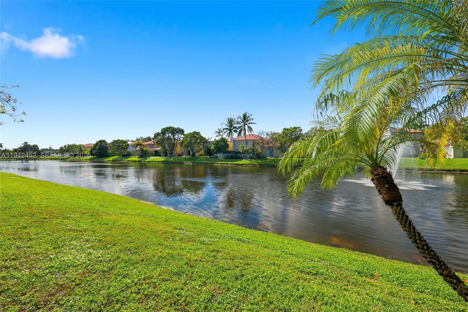 3059 Laurel Ridge Circle Riviera Beach, FL 33404 - Photo 7 of 25 a view of a lake with a yard