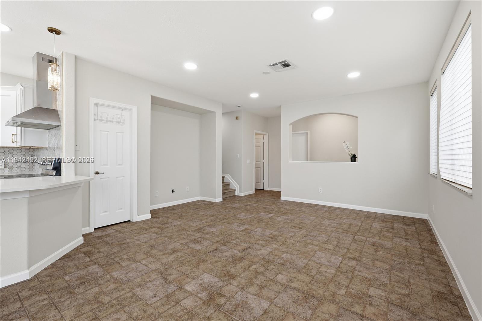 3059 Laurel Ridge Circle Riviera Beach, FL 33404 - Photo 9 of 25 a view of an empty room with kitchen and window