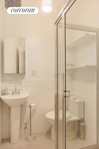 a bathroom with a sink toilet and shower