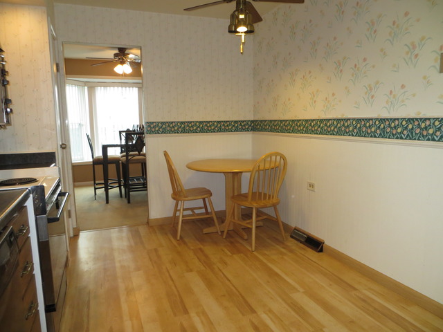 116 Julie Road Bolingbrook, IL 60440 - Photo 3 of 21 a dining room with furniture and wooden floor
