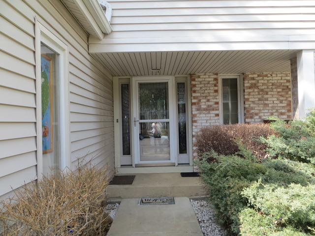 116 Julie Road Bolingbrook, IL 60440 - Photo 21 of 21 a view of a brick house with potted plants