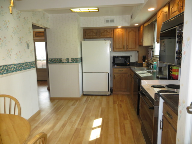 116 Julie Road Bolingbrook, IL 60440 - Photo 4 of 21 a kitchen with a refrigerator a stove top oven a sink and dishwasher