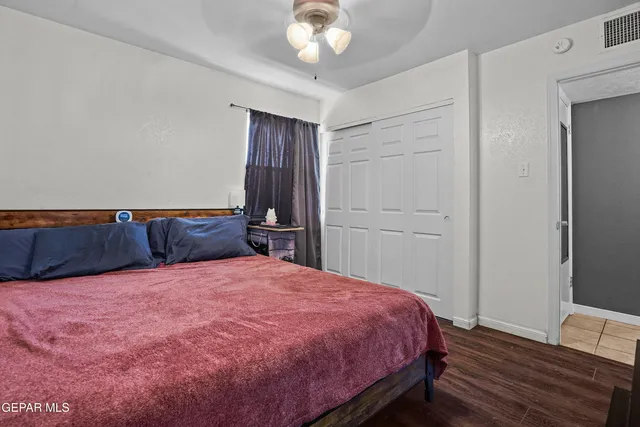 a bedroom with a large bed and a chandelier