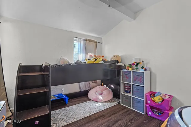 a bedroom with furniture and a window