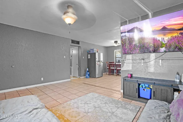 a bedroom with bed and a chandelier