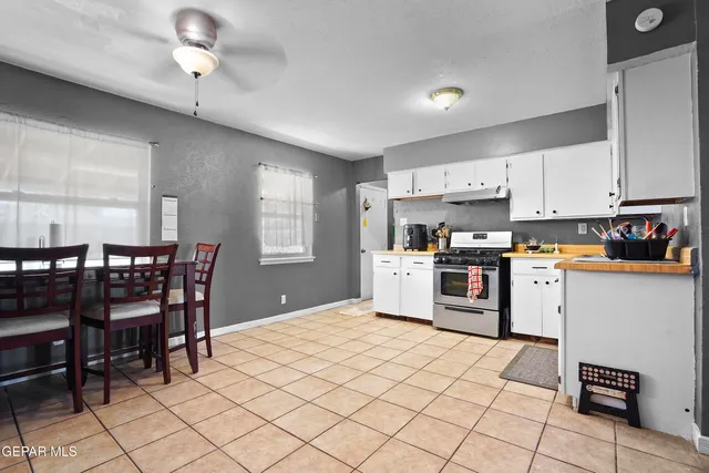 a kitchen with granite countertop cabinets and chairs