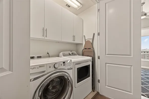 a bedroom with a bed and a flat tv screen on the dresser