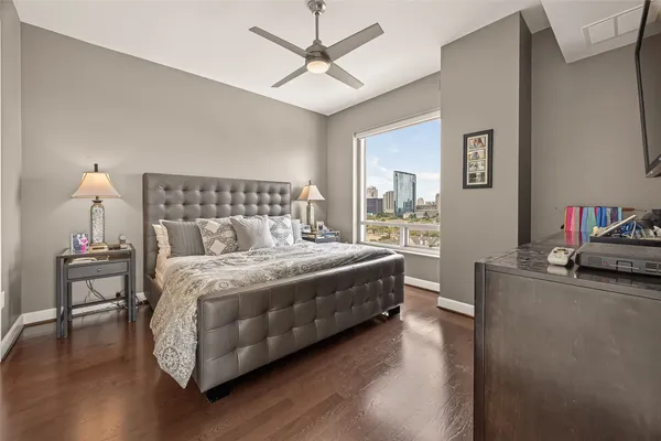 a bedroom with a bed and a flat screen tv