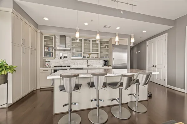 a large kitchen with a table and chairs