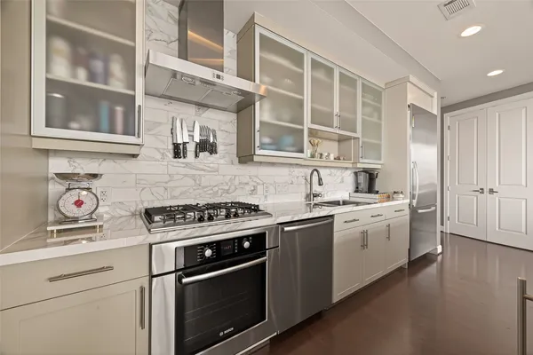 a large kitchen with kitchen island a sink table and chairs