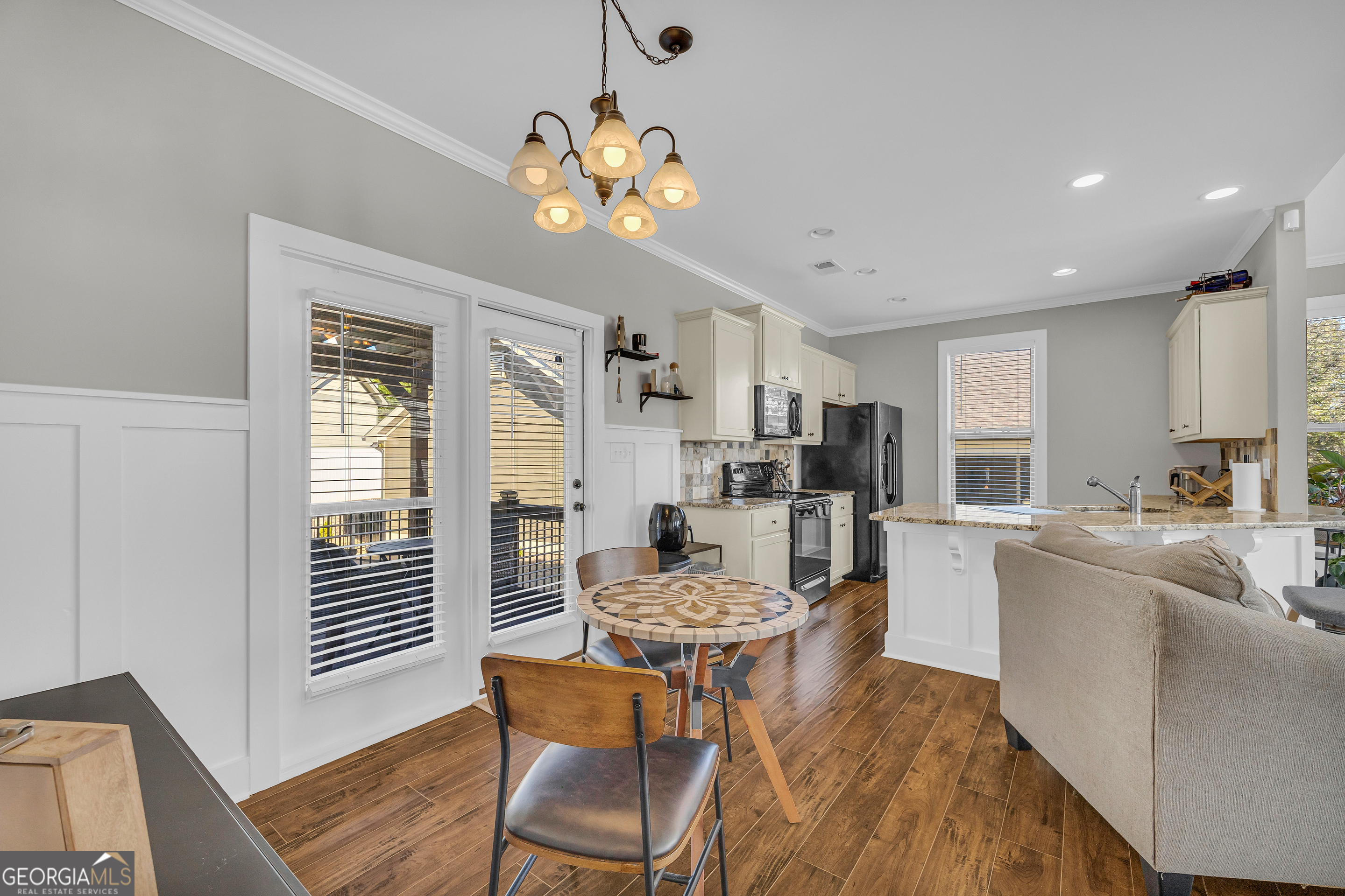 236 Melba Lane Athens, GA 30606 - Photo 9 of 33 a living room with kitchen island furniture and a chandelier