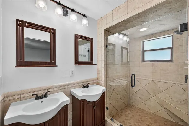 a bathroom with 2 sink and a mirror