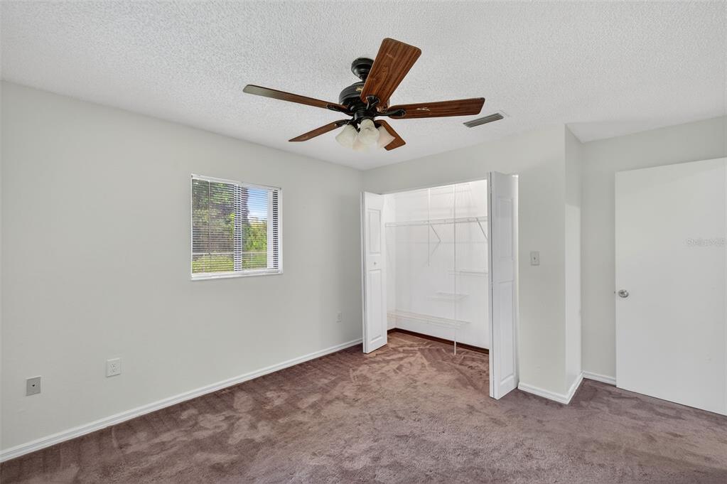 4618 Deeson Road Lakeland, FL 33810 - Photo 16 of 36 an empty room with a window and a ceiling fan