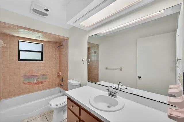 a bathroom with a sink toilet tub and shower