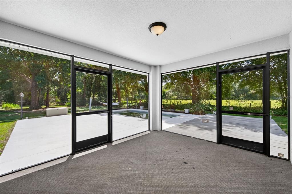 4618 Deeson Road Lakeland, FL 33810 - Photo 20 of 36 a view of an empty room with wooden floor and a floor to ceiling window