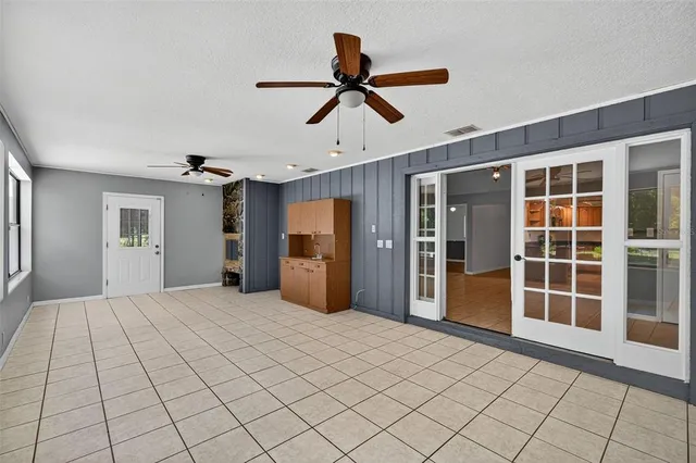 a view of empty room with wooden floor and window
