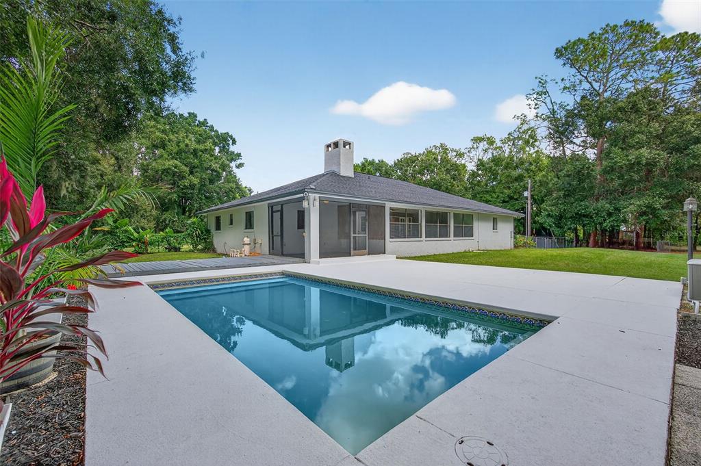 4618 Deeson Road Lakeland, FL 33810 - Photo 26 of 36 a view of house with swimming pool outdoor seating