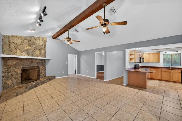 a large kitchen with a stove and a chandelier