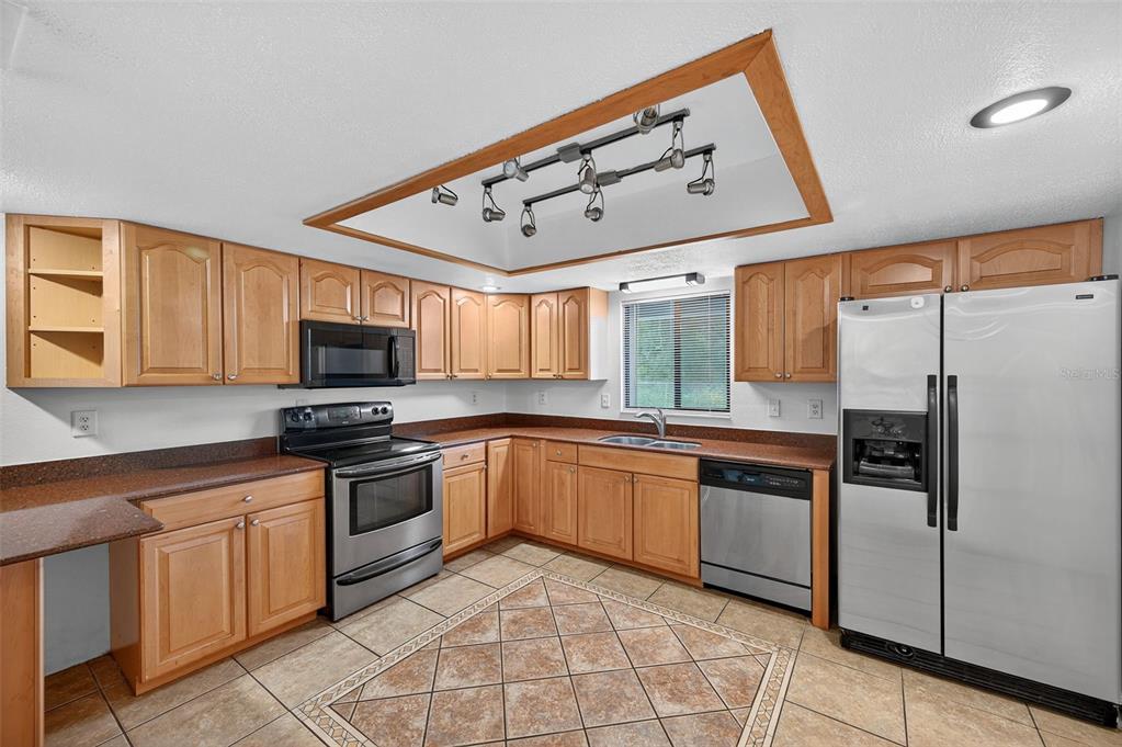 4618 Deeson Road Lakeland, FL 33810 - Photo 10 of 36 a kitchen with stainless steel appliances granite countertop a refrigerator and a stove top oven