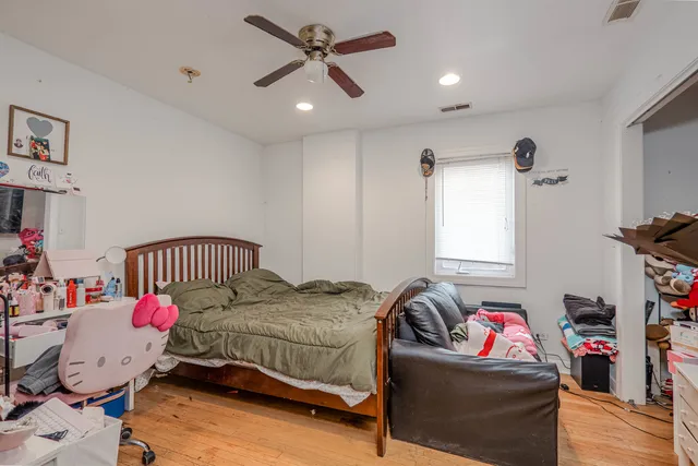 a bedroom with a bed and a chandelier
