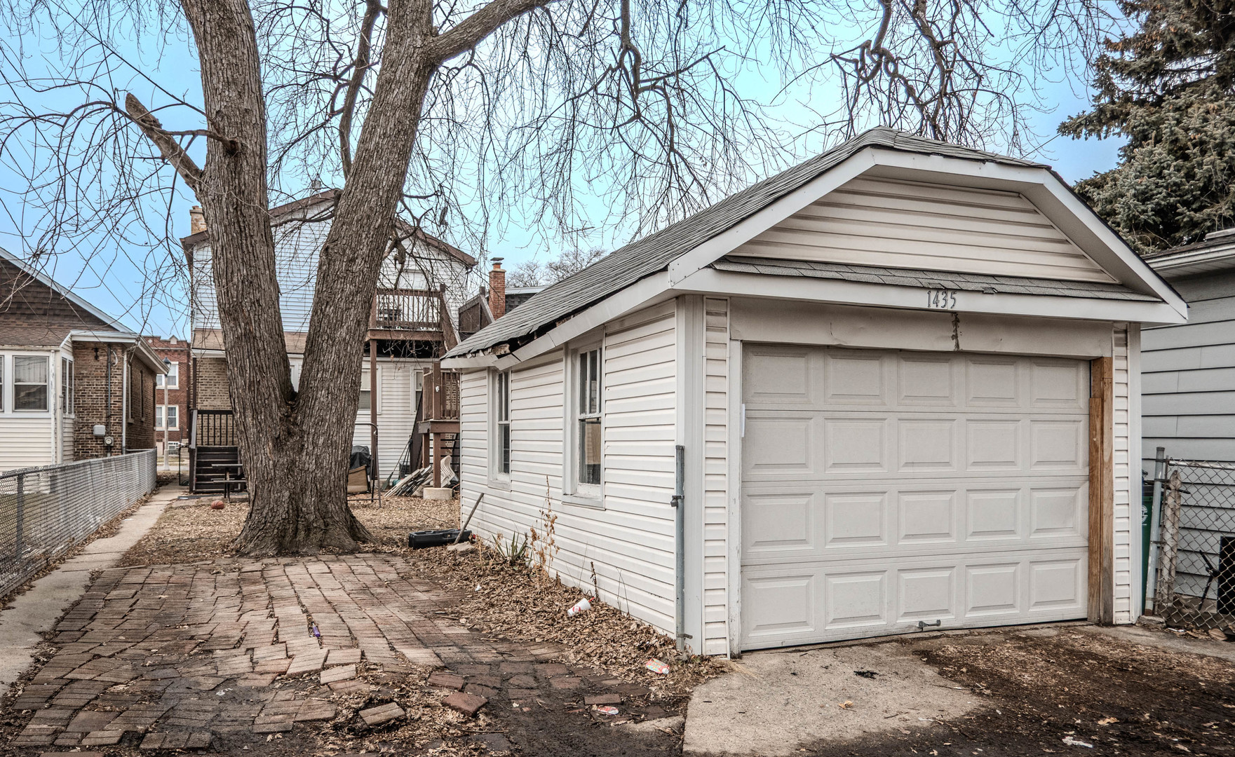 1435 Grove Avenue Berwyn, IL 60402 - Photo 22 of 25 a view of a house with a yard covered with snow