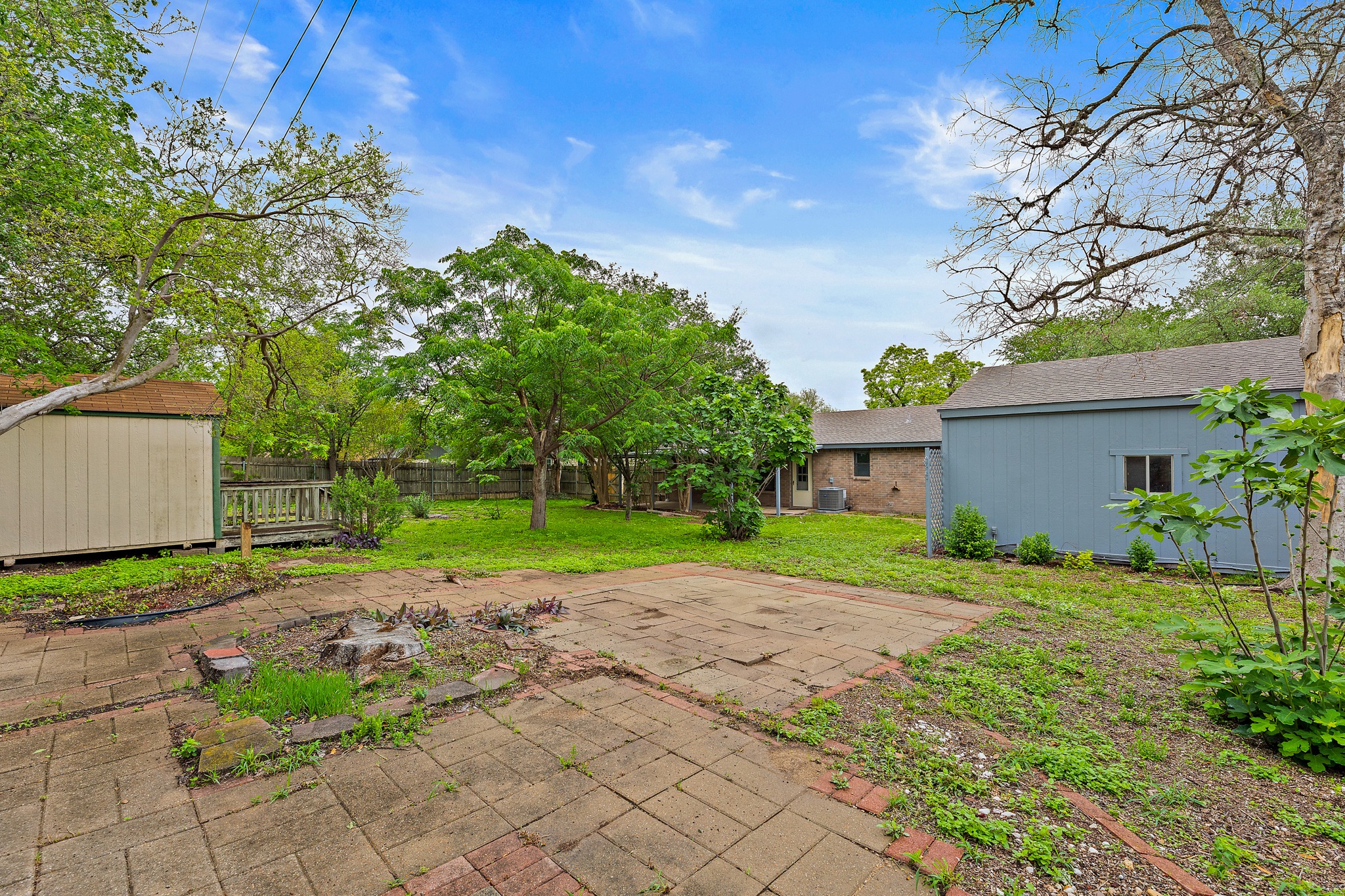 205 Hitching Post Road Kyle, TX 78640 - Photo 18 of 20 The backyard offers a great mix of open space and existing hardscape, giving you a head start on outdoor dining, entertaining, or future landscaping ideas.