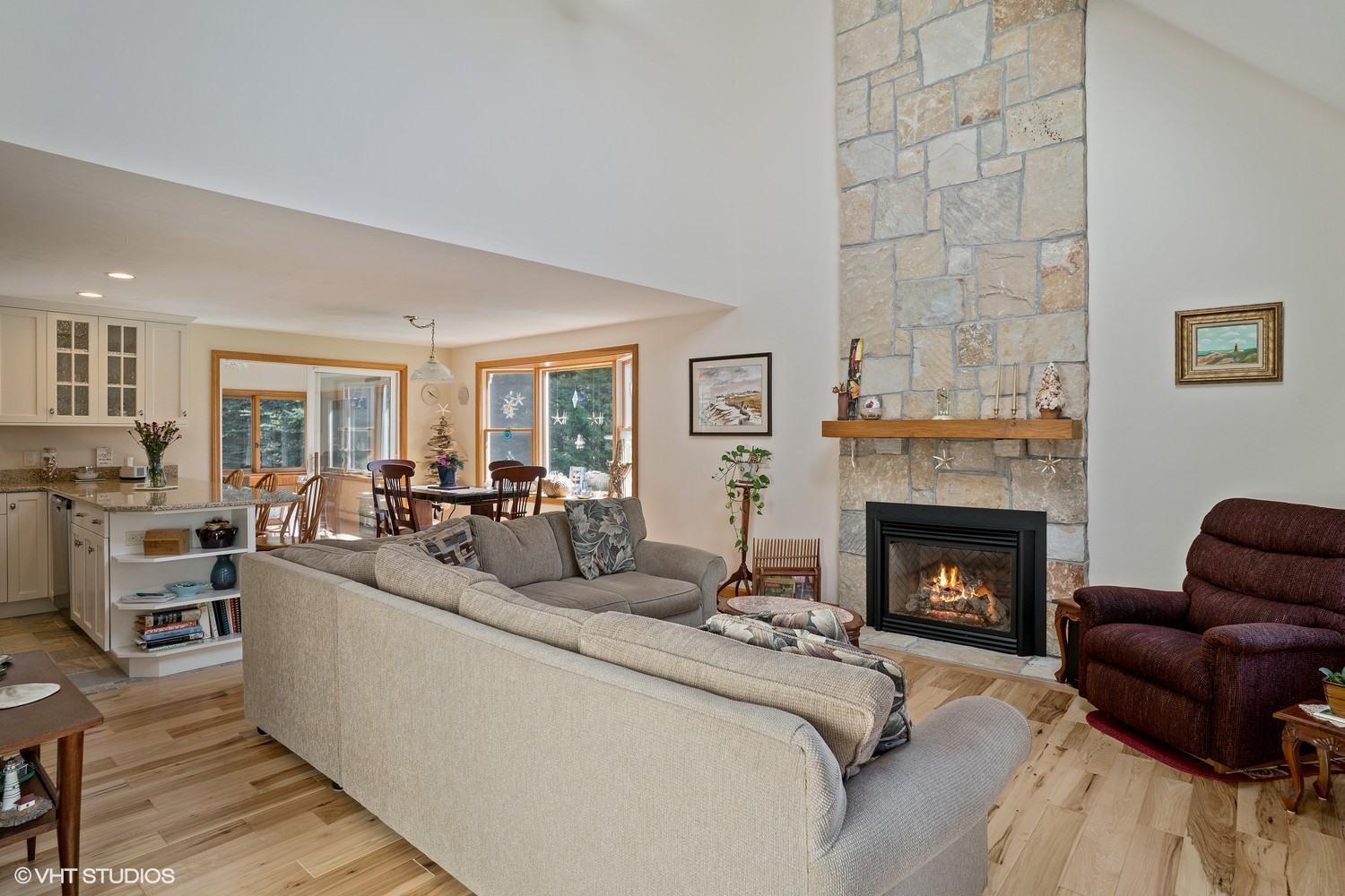 230 Locust Road Eastham, MA 02642 - Photo 3 of 17 a living room with furniture and a fireplace