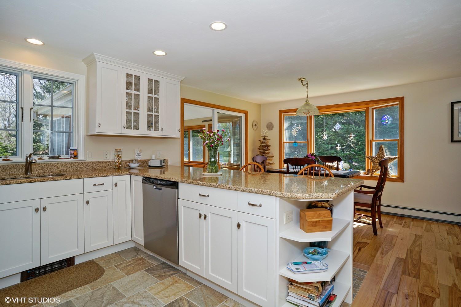 230 Locust Road Eastham, MA 02642 - Photo 4 of 17 a kitchen with a sink dining table and chairs